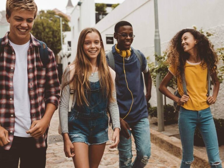 A group of teenagers having fun walking in the city playing the Qugato city game.