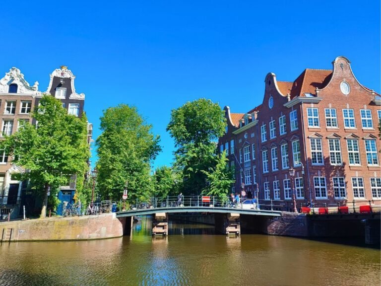 Bridge and canal surrounded by classic Dutch architecture – a stop on the Amsterdam city game map
