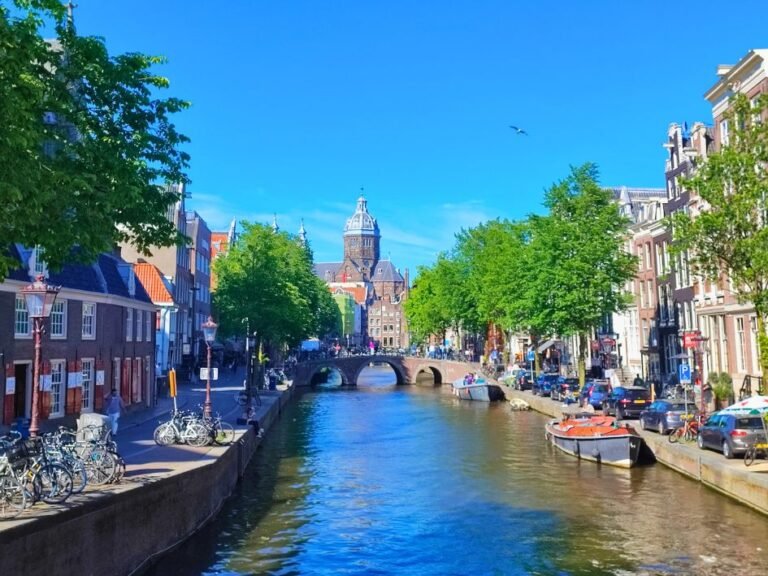 Iconic Amsterdam canal with church tower – part of the city detective game route
