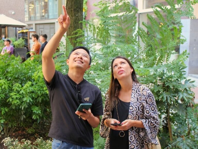 pair-pointing-at-building-number